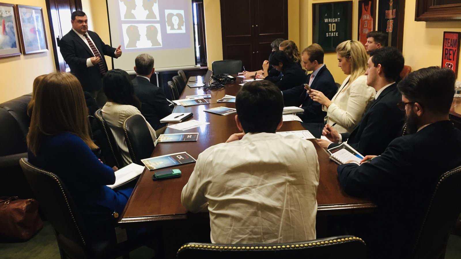 Michael Neblo briefing an office full of staffers