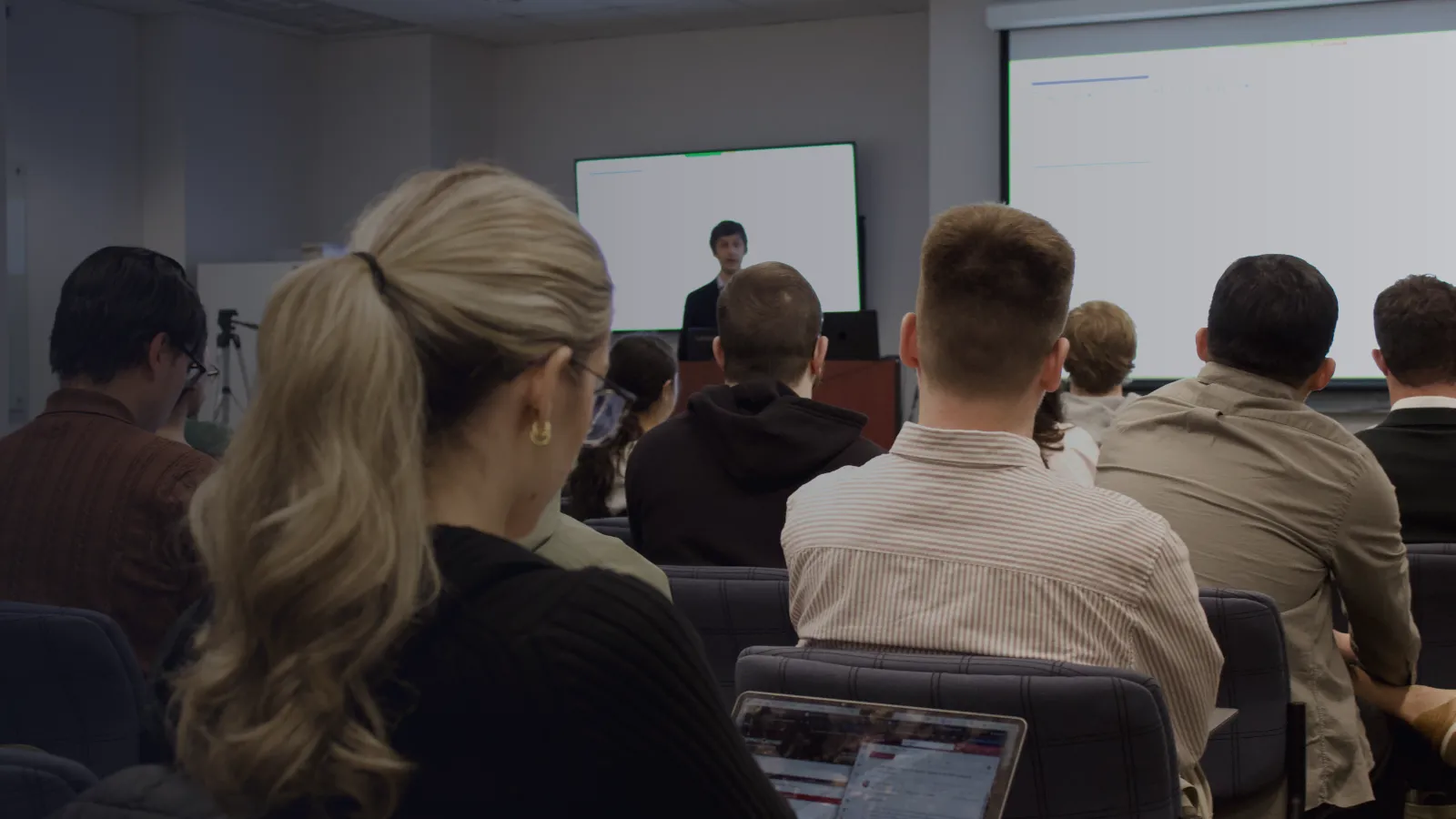 Students in the class are listening attentively to a lecture.