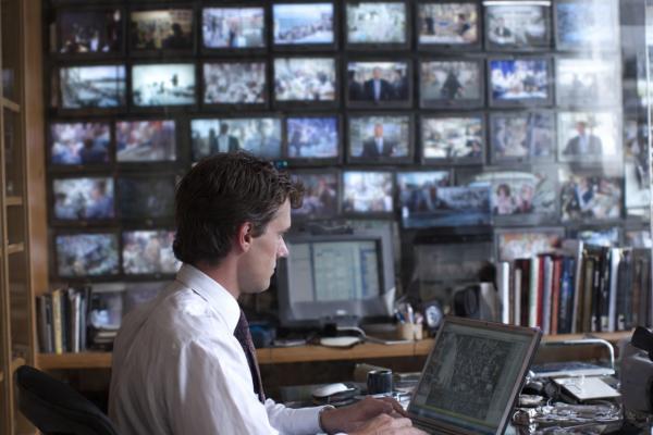 A man sitting in the office using his laptop